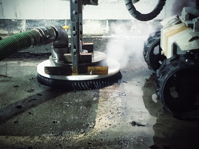 Handheld UHP water jetting concrete surface preparation inside a tunnel by RGL Services