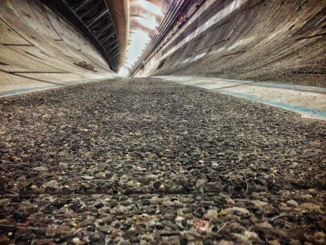 Concrete surface preparation scabbling exposing aggregate in a UK tunnel using UHP water jetting