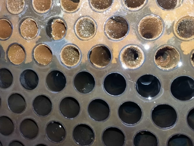 UHP water jetting removing scale from heat exchanger tubes in dairy processing