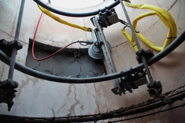Remote-controlled UHP water jetting refractory lining removal inside an industrial vessel in the UK