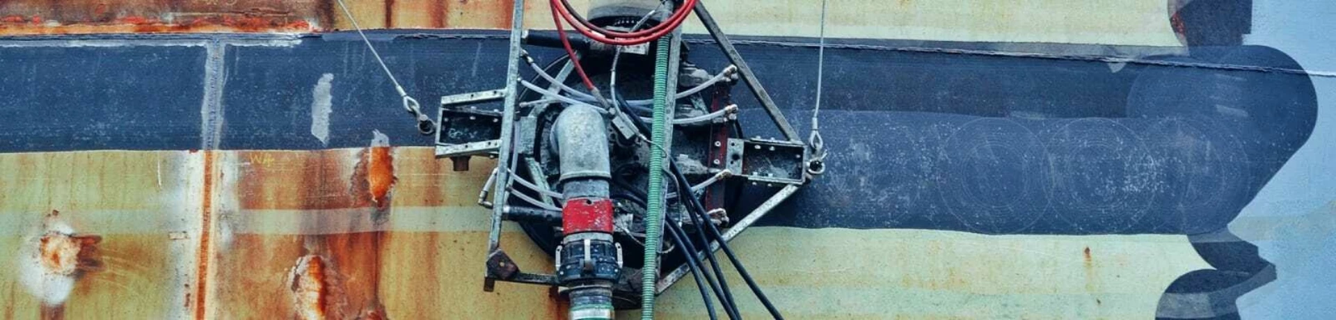 Limpet jetting robot removing coatings from a steel tank, RGL Services